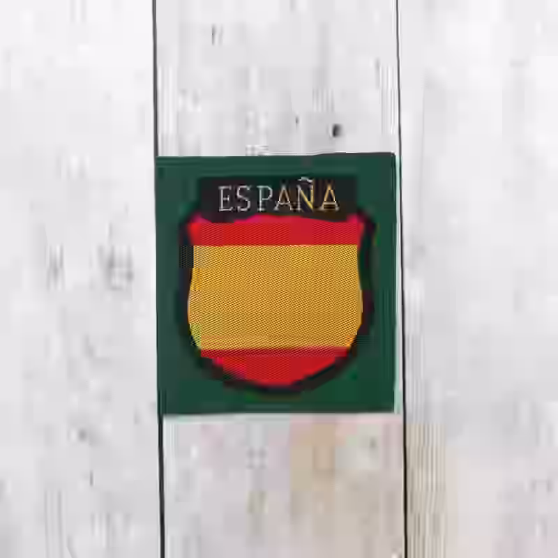 Spanish Division Volunteer Silk Woven Sleeve Shield Spanish Division Volunteer Silk Woven Sleeve Shield – Premium Replica, made of Red and yellow embroidery on darkgreen silk background