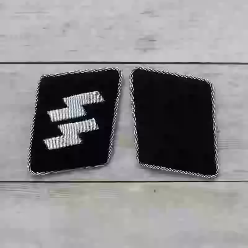 Waffen-SS Officer's Silver Rune Collar Tabs Waffen-SS Officer's Silver Rune Collar Tabs – Premium Replica, made of Hand-embroidered aluminum wire with aluminum piping on black wool background