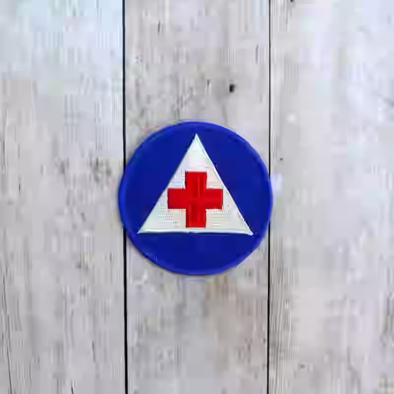 United States Women Army Corps Volunteer Nurses Aid Corps Badge United States Women Army Corps Volunteer Nurses Aid Corps Badge – Premium Replica, made of White triangle and red cross emblem on blue background