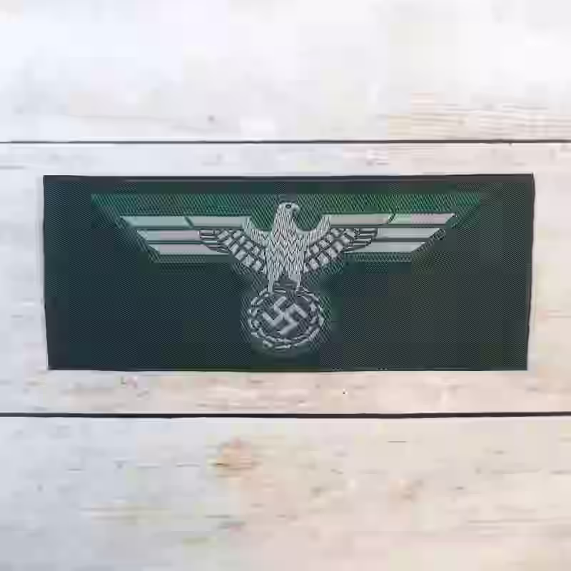 Wehrmacht Army Enlisted Men's Silk Woven Breast Eagle 1940 Wehrmacht Army Enlisted Men's Silk Woven Breast Eagle 1940 – Premium Replica, made of Silk-embroidered grey thread on dark green wool background