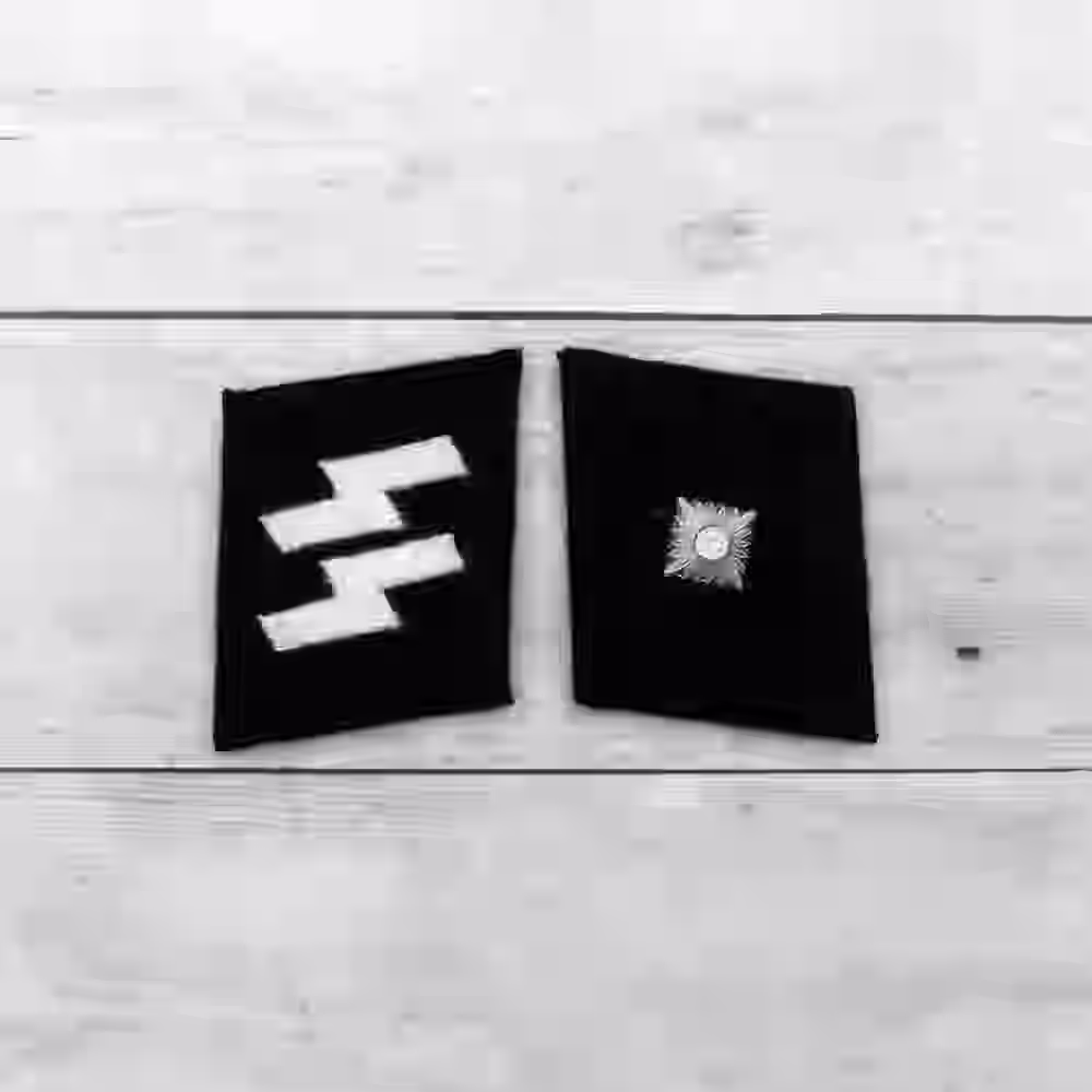 SS Unterscharführer Collar Tabs SS Unterscharführer Collar Tabs – Premium Replica, made of Metallic silver star on black wool background