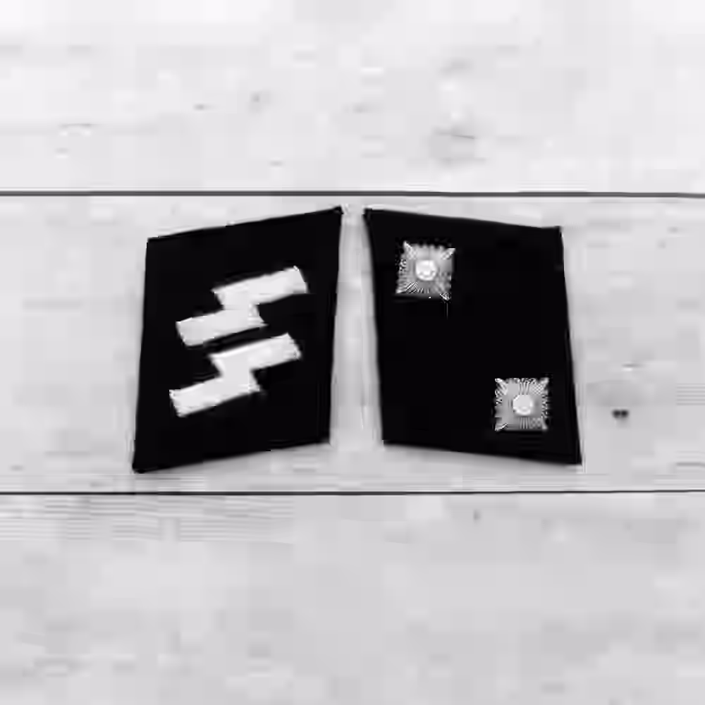 SS Oberscharführer Collar Tabs SS Oberscharführer Collar Tabs – Premium Replica, made of Two metallic silver stars on black wool background