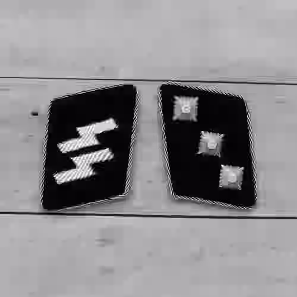 SS Untersturmführer Collar Tabs SS Untersturmführer Collar Tabs – Premium Replica, made of Three metallic silver stars and silver piping on black wool background