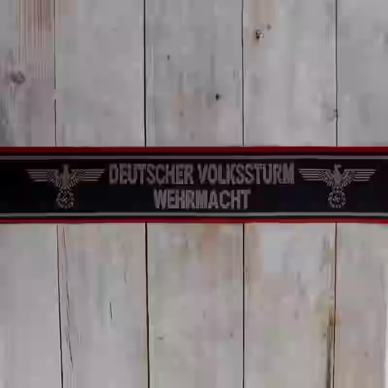 Deutscher Volkssturm Cuff Title Deutscher Volkssturm Cuff Title – Premium Replica, made of Silk woven background with darkgold thread lettering